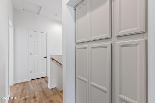 5026 E Retreat Cir, Flagstaff, AZ 86004 - hall with light wood-style flooring, an upstairs landing, and attic access