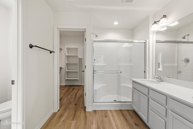5026 E Retreat Cir, Flagstaff, AZ 86004 - full bath with a stall shower, wood finished floors, a spacious closet, vanity, and recessed lighting