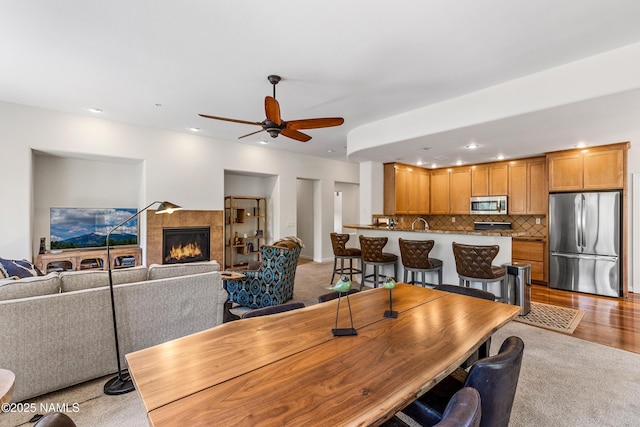 4759 W Quick Draw, Flagstaff, AZ 86005 - dining room with ceiling fan, recessed lighting, a fireplace, and light wood finished floors