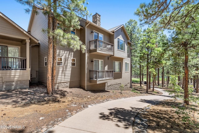 4759 W Quick Draw, Flagstaff, AZ 86005 - view of property exterior featuring a balcony and a chimney