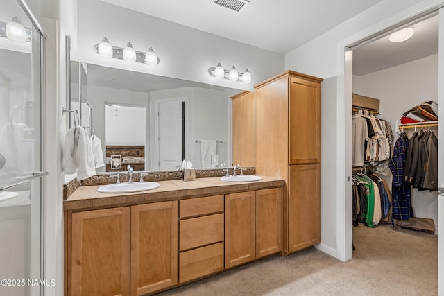 4759 W Quick Draw, Flagstaff, AZ 86005 - ensuite bathroom with double vanity, a stall shower, and a walk in closet