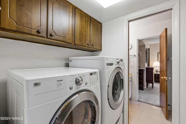 laundry area featuring cabinets and independent washer and dryer