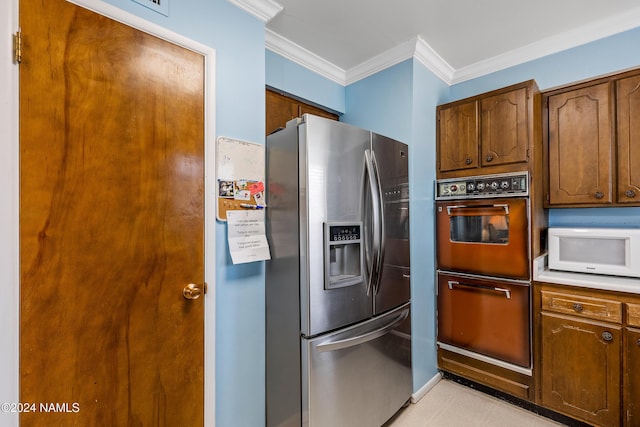 kitchen featuring double wall oven, ornamental molding, and stainless steel refrigerator with ice dispenser