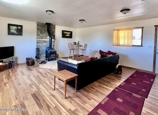 living room with hardwood / wood-style flooring and a wood stove