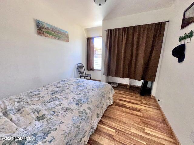 bedroom with hardwood / wood-style floors