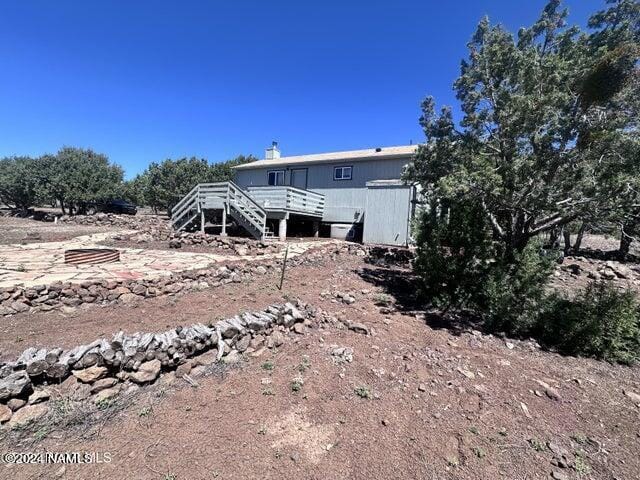 back of property with a wooden deck