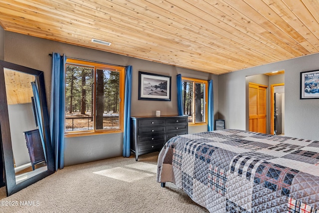 bedroom with carpet, a textured wall, wooden ceiling, and visible vents