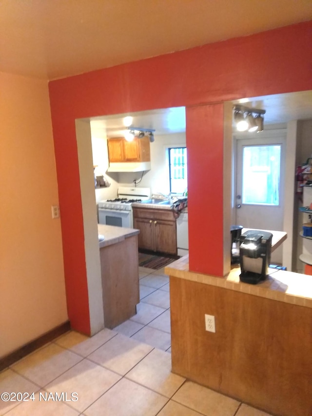 1600 S River Valley Rd, Flagstaff, AZ 86004 - kitchen featuring plenty of natural light, white appliances, light countertops, and light tile patterned floors