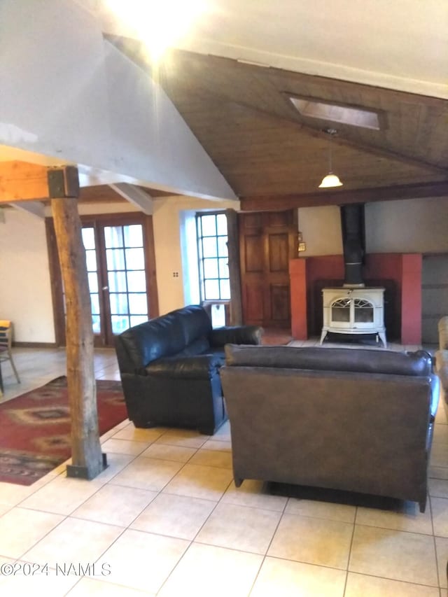 1600 S River Valley Rd, Flagstaff, AZ 86004 - living area with light tile patterned floors, a wood stove, and vaulted ceiling