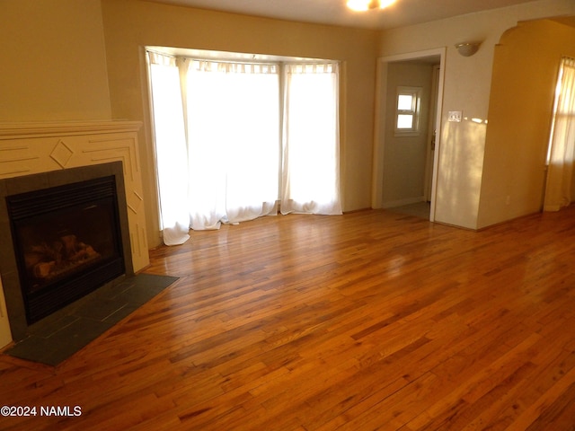 unfurnished living room with wood-type flooring