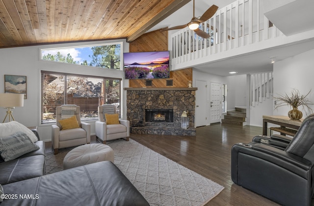 living area featuring wood ceiling, a fireplace, dark wood-style flooring, and stairs