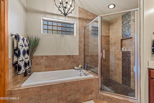 bathroom with independent shower and bath, vanity, and a chandelier