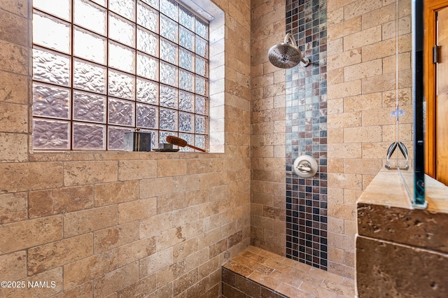 bathroom with a tile shower