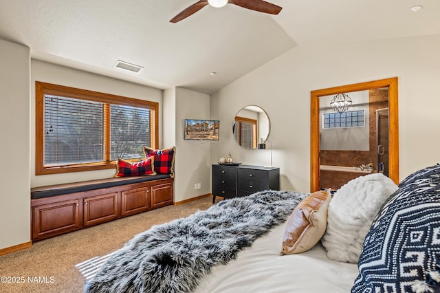 carpeted bedroom with vaulted ceiling, ceiling fan, and ensuite bathroom