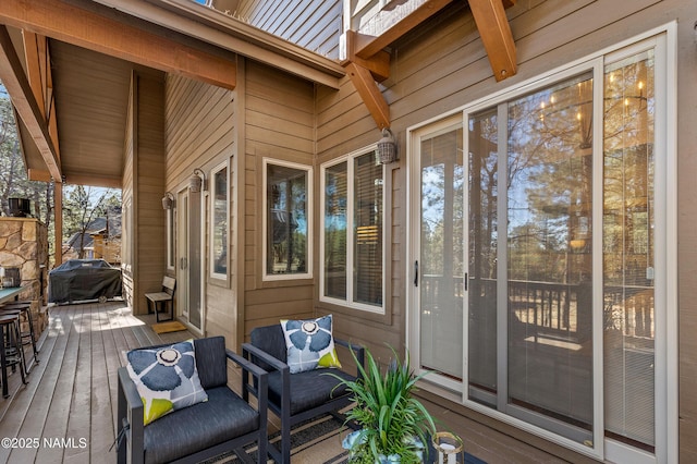 wooden terrace featuring a grill