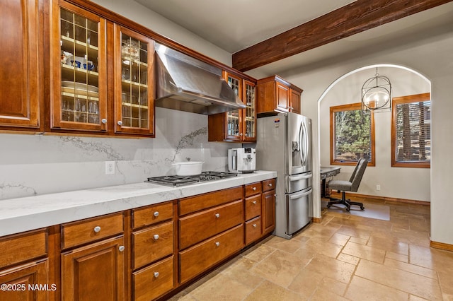 kitchen featuring pendant lighting, appliances with stainless steel finishes, range hood, light stone countertops, and beamed ceiling