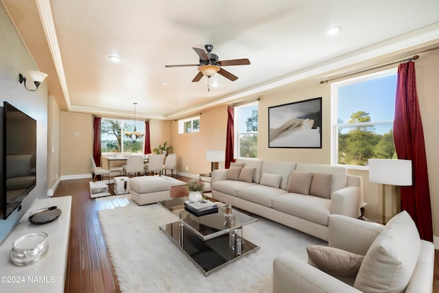 living room with hardwood / wood-style flooring, ceiling fan, and ornamental molding