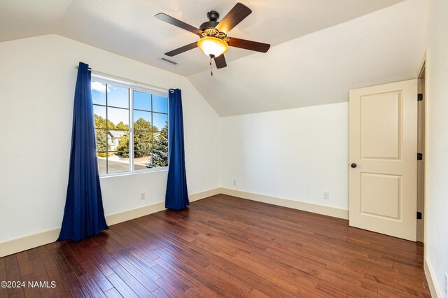 additional living space with ceiling fan, dark hardwood / wood-style flooring, and vaulted ceiling