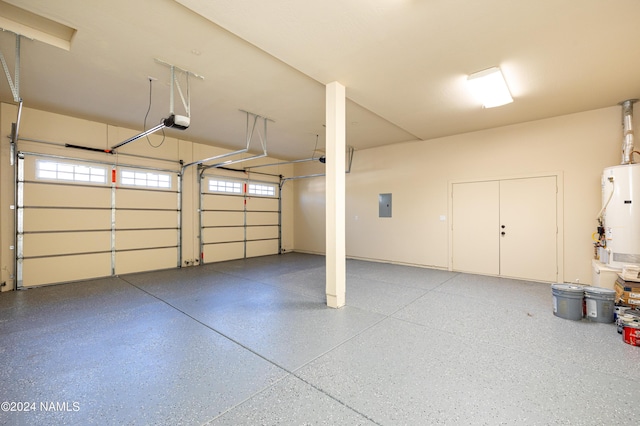 garage featuring electric panel, water heater, and a garage door opener