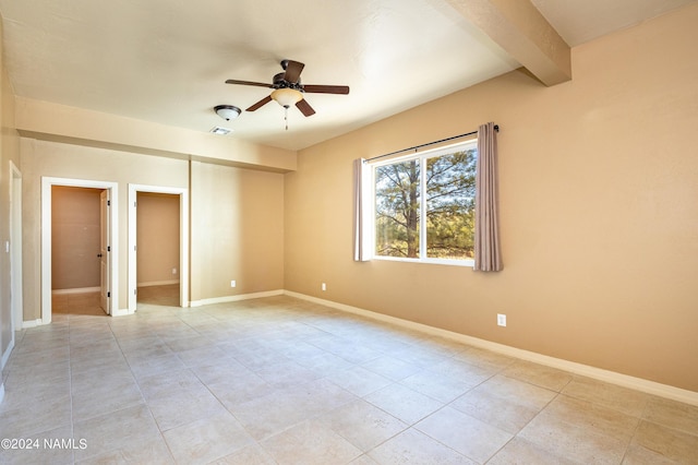 unfurnished room with ceiling fan, beamed ceiling, and light tile patterned flooring