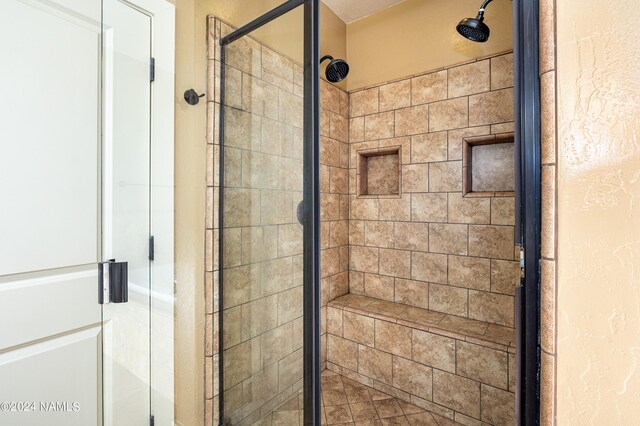 bathroom featuring a shower with shower door