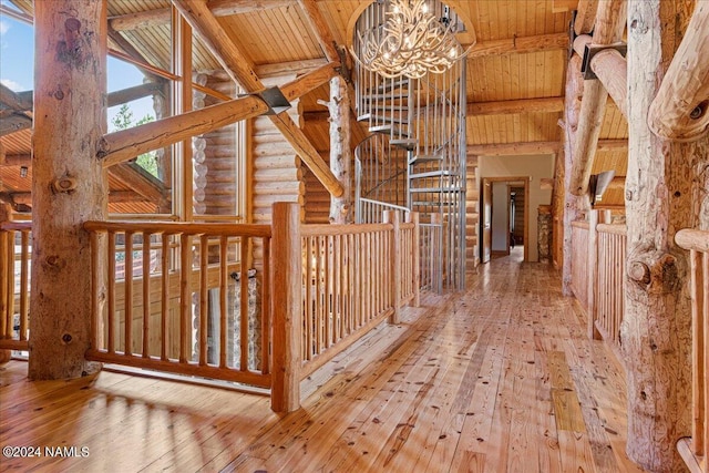 corridor with hardwood / wood-style floors, beamed ceiling, rustic walls, and wood ceiling