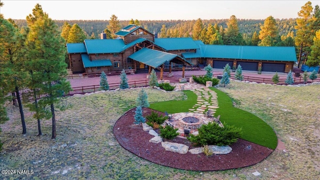 exterior space featuring a garage and an outdoor fire pit