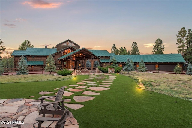 yard at dusk featuring a patio