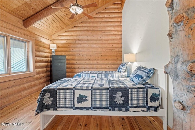 unfurnished bedroom featuring ceiling fan, rustic walls, wood ceiling, and vaulted ceiling with beams