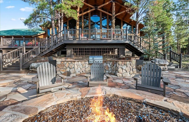 rear view of house with a patio area and a fire pit