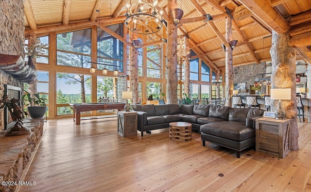 living room featuring wooden ceiling, light hardwood / wood-style flooring, beamed ceiling, and high vaulted ceiling