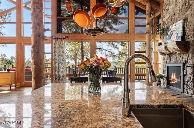 interior space featuring sink, a high ceiling, and a fireplace