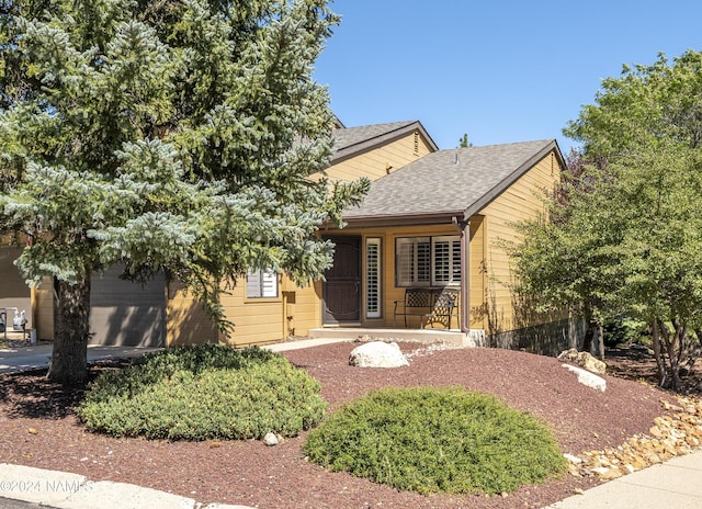 view of front of property featuring a garage and covered porch