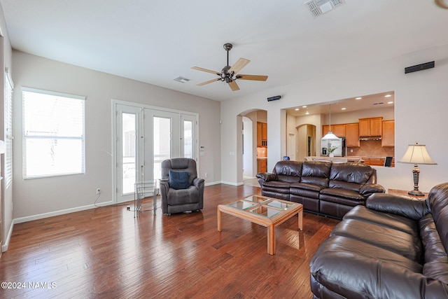 living room with ceiling fan and dark hardwood / wood-style flooring