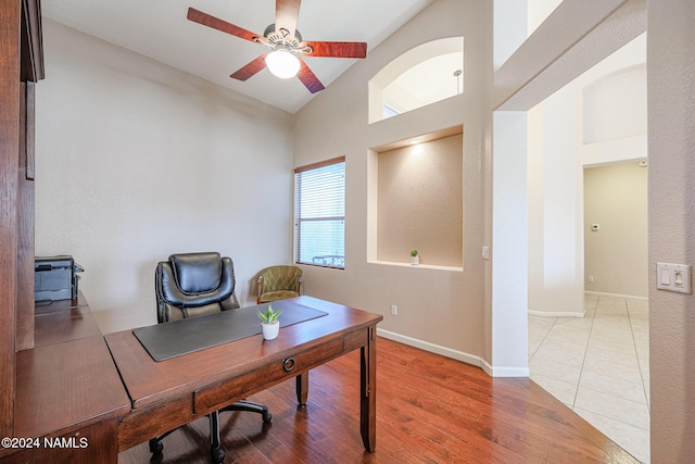 office area with ceiling fan, light hardwood / wood-style flooring, and vaulted ceiling