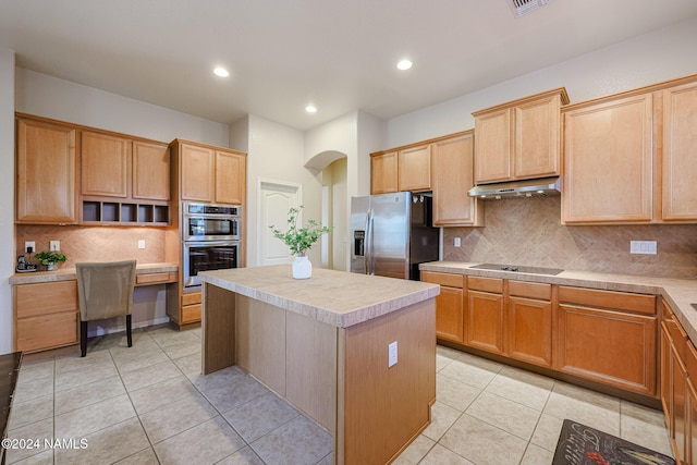 kitchen with backsplash, appliances with stainless steel finishes, a center island, and light tile patterned flooring