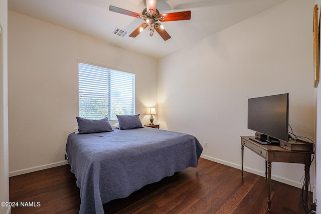 bedroom with dark hardwood / wood-style floors and ceiling fan