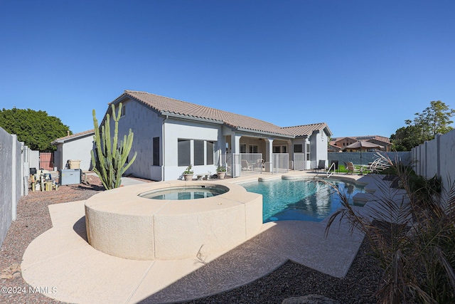 view of pool with an in ground hot tub and a patio