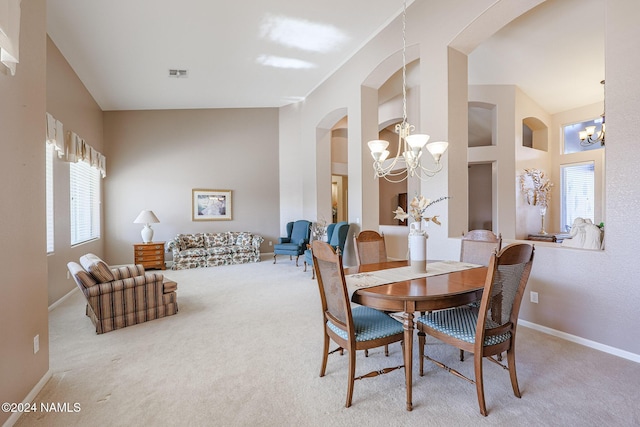 dining space featuring a chandelier and carpet flooring