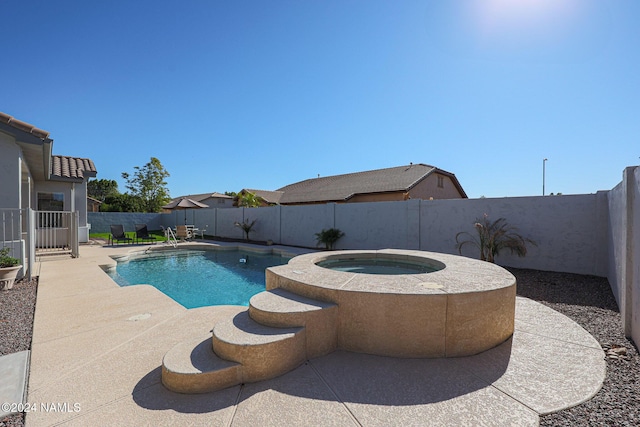 view of pool featuring an in ground hot tub and a patio area