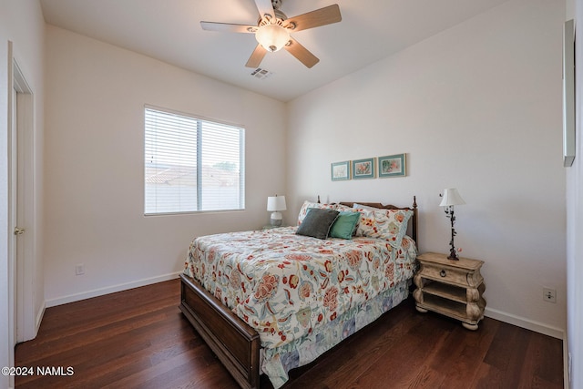 bedroom with dark hardwood / wood-style floors and ceiling fan