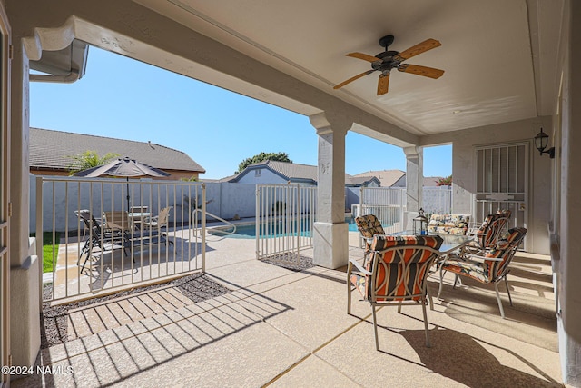 view of patio / terrace with a fenced in pool and ceiling fan