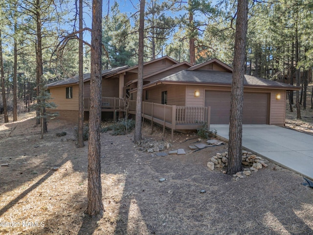 view of front of house featuring a garage and a wooden deck