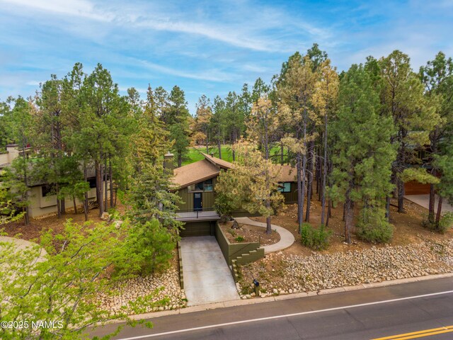 6205 N Country Club Dr, Flagstaff, AZ 86004 - view of property hidden behind natural elements featuring concrete driveway and an attached garage