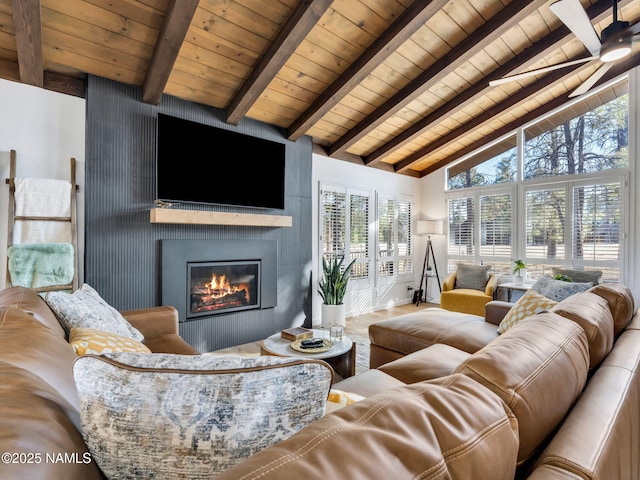 6205 N Country Club Dr, Flagstaff, AZ 86004 - living area with wood ceiling with exposed beams, a large fireplace, plenty of natural light, high vaulted ceiling, and wood finished floors
