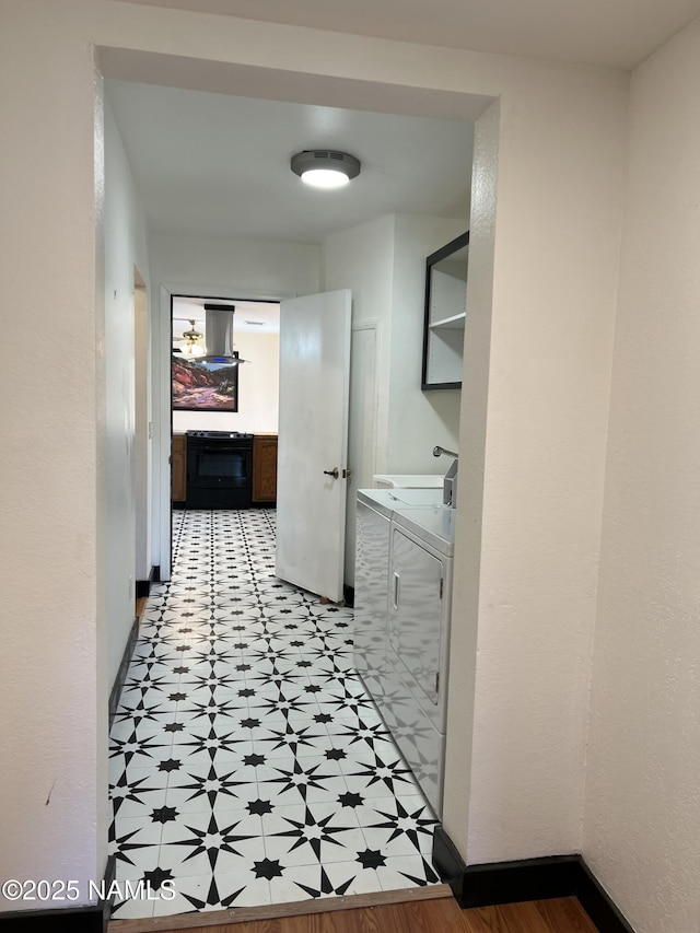 corridor featuring washer and clothes dryer and sink