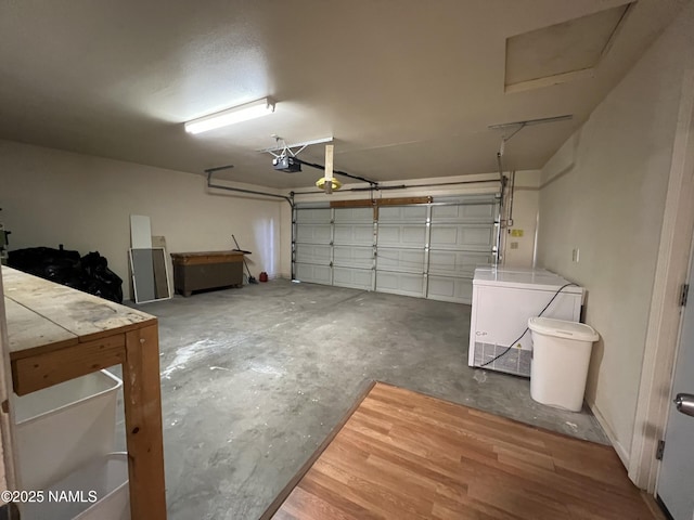 garage with a garage door opener and refrigerator