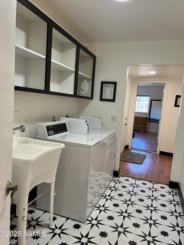 clothes washing area featuring sink and independent washer and dryer