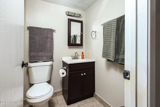 bathroom featuring vanity, toilet, and tile patterned flooring