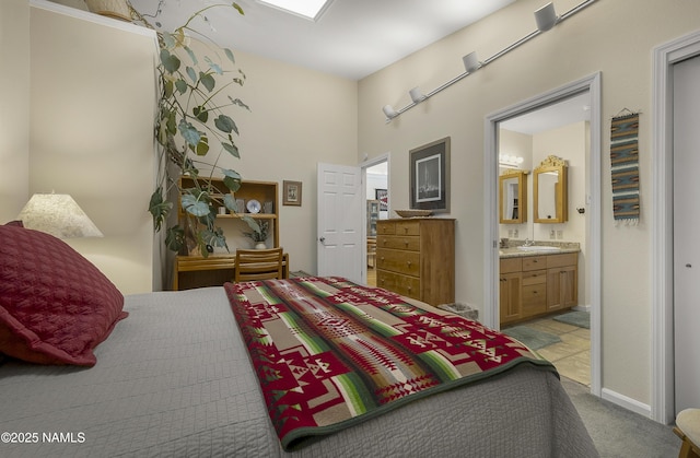 bedroom featuring connected bathroom, carpet, and a sink